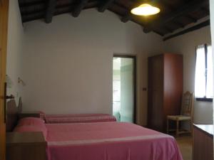 מיטה או מיטות בחדר ב-Agriturismo Orsaiola