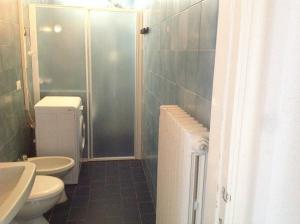 a bathroom with a shower and a toilet and a sink at Alba Appartamenti in Sottomarina +25 photos