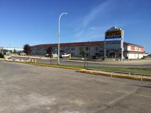 an empty street in front of a building at Western Budget Motel #1 Grande Prairie in Grande Prairie