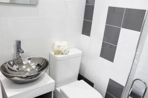 a bathroom with a bowl sink on top of a toilet at Bracara Guest House "Biblioteca" in Braga