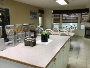 a room with a counter with vases on it at Western Budget Motel #1 Grande Prairie in Grande Prairie