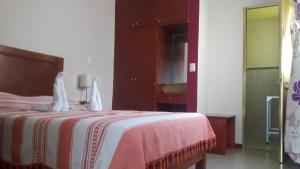 Hotel Florida Oaxaca tesisinde bir odada yatak veya yataklar