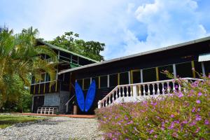 a building with a blue surfboard painted on it at Hotel Nuquimar in Nuquí