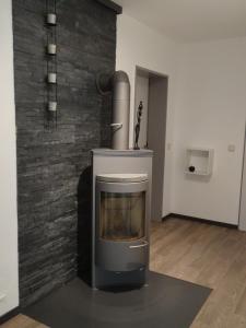a fireplace in a room with a brick wall at Stadt und Wald in Trier