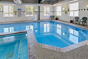 a large pool with blue water in a building at Yellowstone West Gate Hotel in West Yellowstone