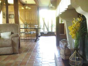 a living room with a couch and a table at La maison du bûcheron in Futeau