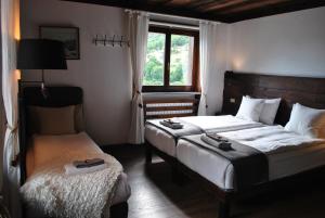 a bedroom with two beds and a window at Hotell Millefiori- Alpine Event Lodge in Valtournenche