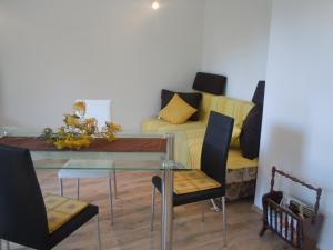 ein Esszimmer mit einem Glastisch und einem Sofa in der Unterkunft Apartments Tri sestrice in Sveta Nedelja