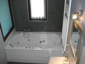 a white bath tub in a bathroom with a window at Posada la Desmera in Isla