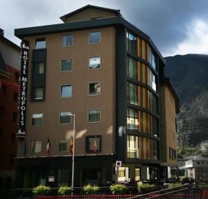 a building with a mountain in the background at Hotel Metropolis in Andorra la Vella