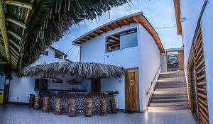 a building with a bar in the middle of it at Akas Hotel Apartamentos in Canoas de Punta Sal