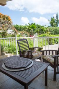 a wooden table and two chairs on a patio at Gordian Terrace in Spanish Town