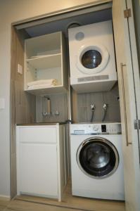 a laundry room with a washing machine and a washer at Taumeasina Island Resort in Apia