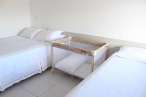 Cama ou camas em um quarto em Nannai Flat Duplex Muro Alto