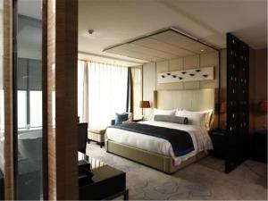 Postel nebo postele na pokoji v ubytování Tangla Hotel Tianjin
