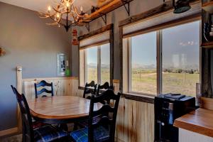 a dining room with a table and some windows at Mountain Haven Cabins in Mountain View