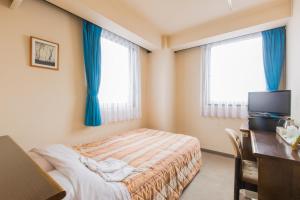 Postel nebo postele na pokoji v ubytování Hotel New Neo
