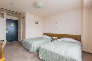 Postel nebo postele na pokoji v ubytování Hotel New Neo