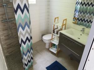 a bathroom with a toilet and a sink at ChEZ MAYAH in Le Gosier +6 photos