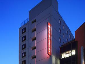 
a large building with a clock on the front of it at Hotel Pearl City Morioka in Morioka
