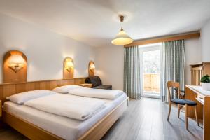 מיטה או מיטות בחדר ב-Pensione Vittoria