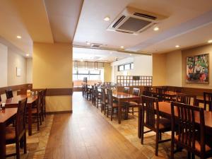 a dining room with wooden tables and chairs at Hotel Pearl City Morioka in Morioka +23 photos