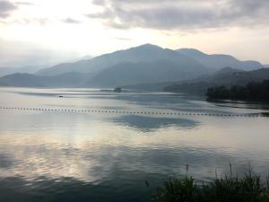 a view of a lake with mountains in the background at Sun Fog Hotel in Yuchi