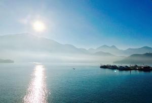 a large body of water with mountains in the background at Sun Fog Hotel in Yuchi