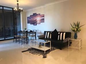 a living room with a black couch and a table at Shine Apartment in Liverpool