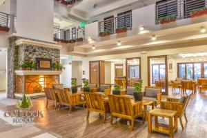 a lobby with tables and chairs and a fireplace at Outlook Ridge Residences in Baguio