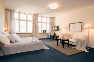 Säng eller sängar i ett rum på Carlstadt Suites Düsseldorf