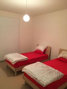 a room with two beds with red sheets at Beit Misk in Beirut