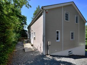 a large gray building with a garage at Cozy Chalet in Soy with Sauna in Biron