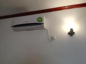 a printer on a wall with a light on it at Mathews Holiday Resort in Habarana