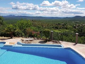 a swimming pool with a view of the mountains at Peaceful villa with private pool in Courry