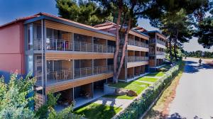 an apartment building with balconies and a street at Blue Dolphin Hotel in Metamorfosi