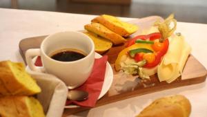 a tray of food with a cup of coffee and bread at Penzión Anna Pieniny in Spišská Stará Ves