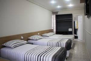 Postel nebo postele na pokoji v ubytování Hotel Dois Irmãos