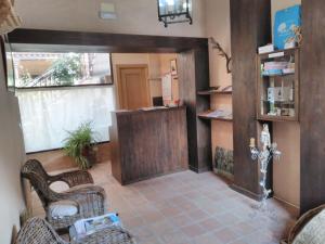 a lobby with a reception desk and wicker chairs at La Venta del Arriero in Retuerta de Bullaque