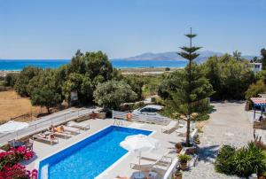 a resort with a swimming pool and a beach at Dina Naxos Studios in Agios Prokopios