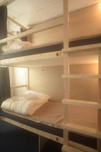 a room with two bunk beds in a room at Wharf Inn in Yokohama