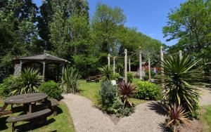 a garden with a picnic table and a gazebo at Crown, Droitwich by Marston's Inns in Droitwich