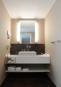 a bathroom with a sink and a mirror at Hotel & Restaurant Schönau in Peine