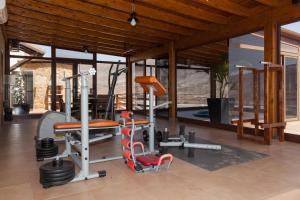a gym with treadmills and weights in a house at Casa Guisguey in Guisguey