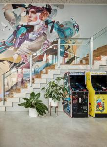a mural of a superhero on a wall next to a staircase at Sir Adam Hotel, part of Sircle Collection in Amsterdam