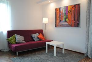 a living room with a couch and a lamp at MT Apartments in Nowy Tomyśl