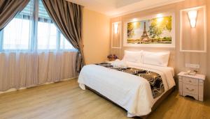 Postel nebo postele na pokoji v ubytování Lavender Inn USJ