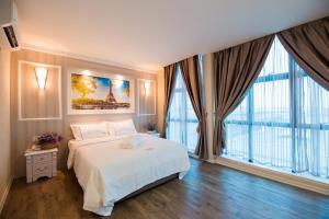 Postel nebo postele na pokoji v ubytování Lavender Inn USJ