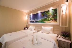 Postel nebo postele na pokoji v ubytování Lavender Inn USJ