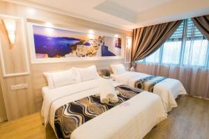Postel nebo postele na pokoji v ubytování Lavender Inn USJ